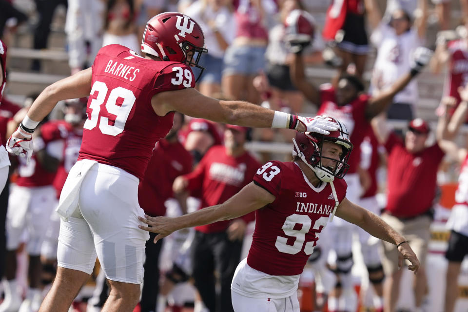 Indiana place kicker Charles Campbell (93) celebrates with tight end Ryan Barnes (39) after Campbell kicked the game winning field goal in overtime of an NCAA college football game against Western Kentucky, Saturday, Sept. 17, 2022, in Bloomington, Ind. Indiana won 33-30 in overtime. (AP Photo/Darron Cummings)