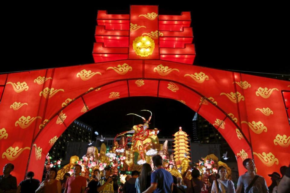 People pass a Monkey King lantern at the River Hongbao Lunar New Year celebrations at the Marina Bay floating platform on 6 February. Photo: Reuters/Edgar Su.