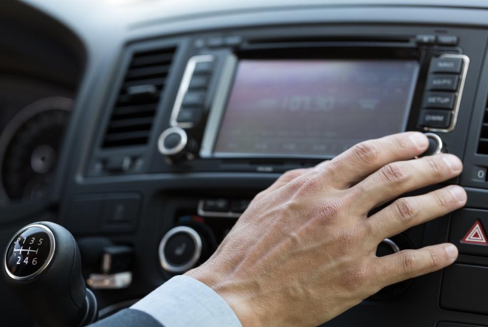 A person listening to satellite radio in their car.