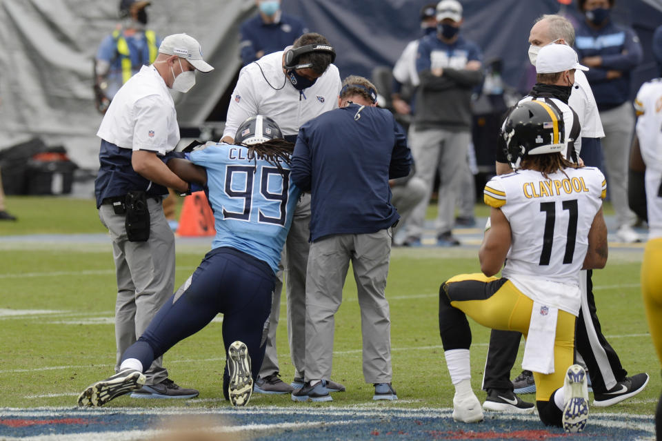 Tennessee Titans linebacker Jadeveon Clowney (99) is helped up after being injured in the second half of an NFL football game against the Pittsburgh Steelers Sunday, Oct. 25, 2020, in Nashville, Tenn. (AP Photo/Mark Zaleski)