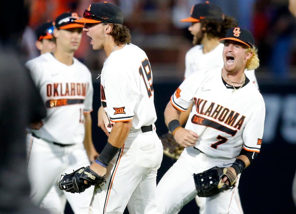Oklahoma State's Roc Riggio (7) and Marcus Brown (19) celebrate following the NCAA Stillwater Regional baseball game between Oklahoma State Cowboys and Missouri State Bears at the O'Brate Stadium in Stillwater, Okla., Friday, June, 3, 2022. 