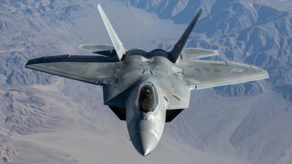 An F-22 Raptor flies over the Nevada Test and Training Range. <em>USAF</em>