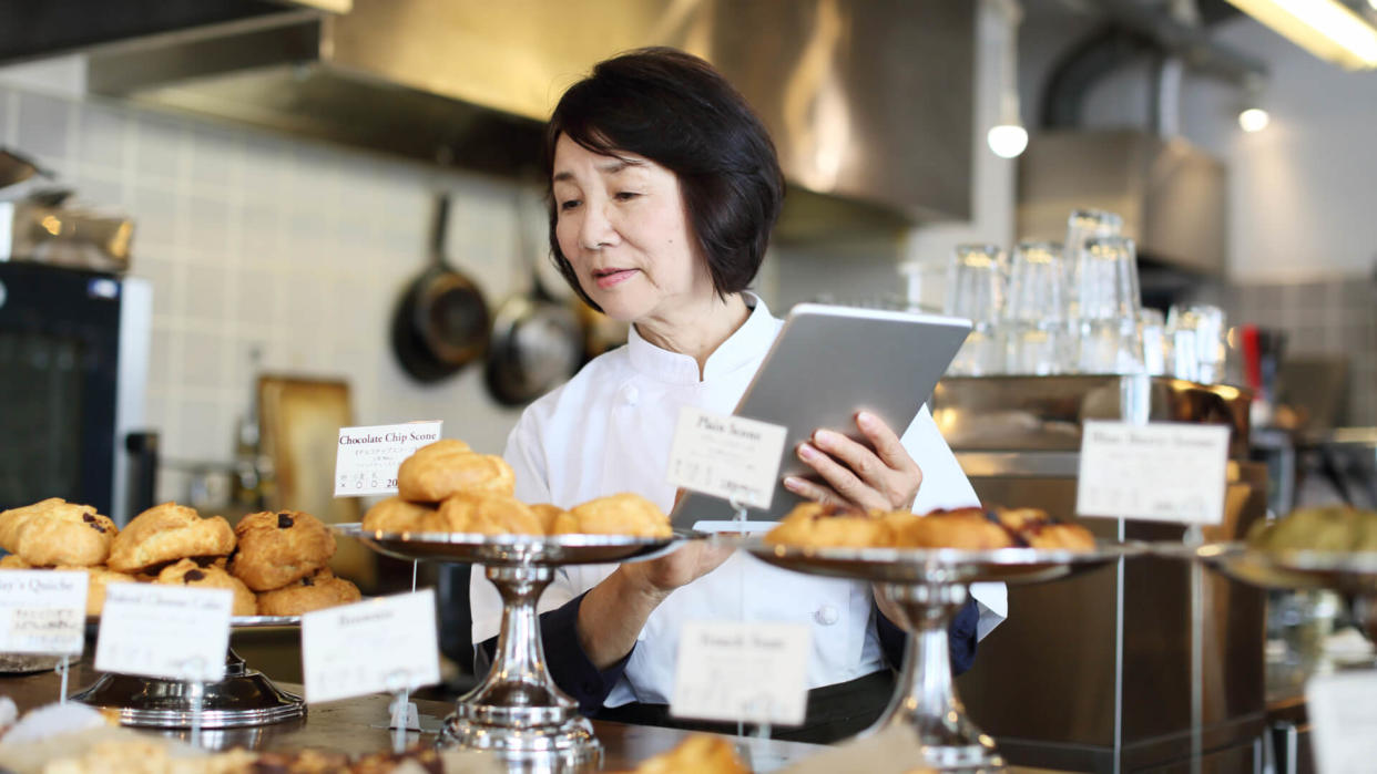 a baker checking her stock in the morning