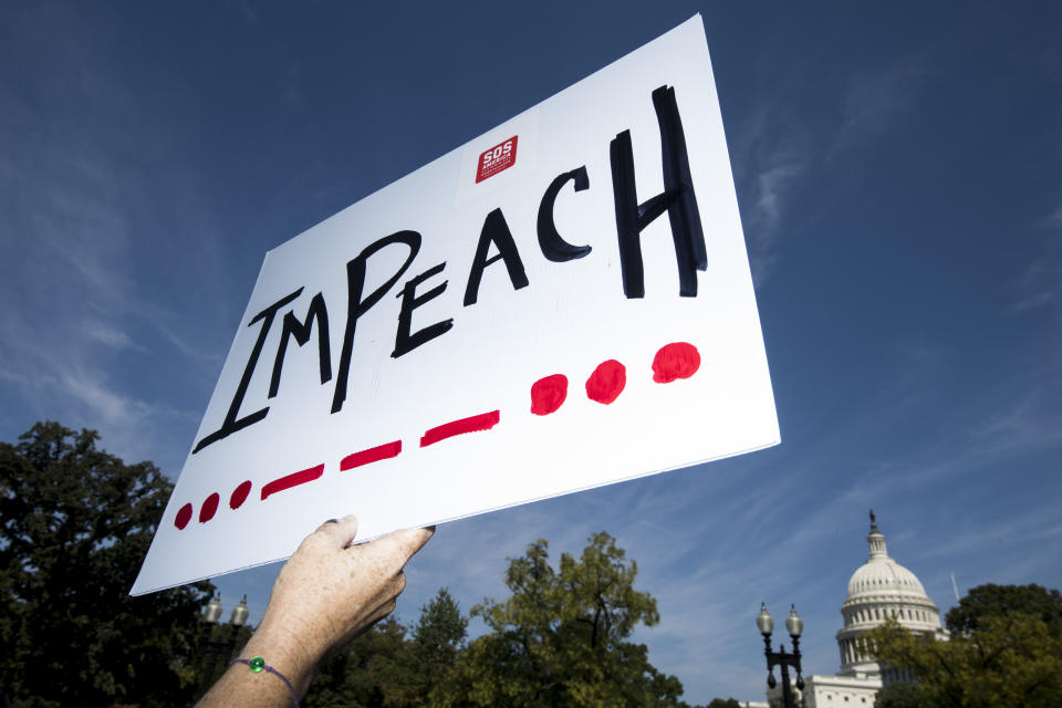 UNITED STATES - SEPTEMBER 23: A woman holds an impeach sign as Rep. Al Green, D-Texas, and Rep. Rashida Tlaib, D-Mich., speak to a group of protesters and the media about the need to impeach President Donald Trump in front of the Rayburn House Office Building on Monday, Sept. 23, 2019. The event was originally slated to coincide with the House Judiciary Committees hearing on corruption, but the hearing was postponed. (Photo By Bill Clark/CQ-Roll Call, Inc via Getty Images) (Photo: Bill Clark via Getty Images)