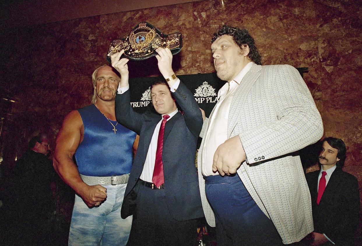 Real estate developer Donald Trump holds the World Wrestling Federation Championship belt as he flanked by Wrestlers Hulk Hogan, left and Andre the Giant at a news conference Tuesday, March 15, 1988, in New York announcing 