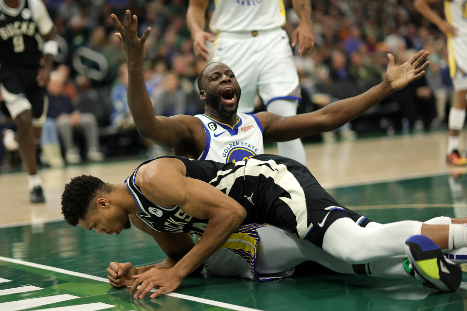 MILWAUKEE, WISCONSIN - DECEMBER 13: Giannis Antetokounmpo #34 of the Milwaukee Bucks is fouled by Draymond Green #23 of the Golden State Warriors during the first half of a game at Fiserv Forum on December 13, 2022 in Milwaukee, Wisconsin. NOTE TO USER: User expressly acknowledges and agrees that, by downloading and or using this photograph, User is consenting to the terms and conditions of the Getty Images License Agreement. (Photo by Stacy Revere/Getty Images)