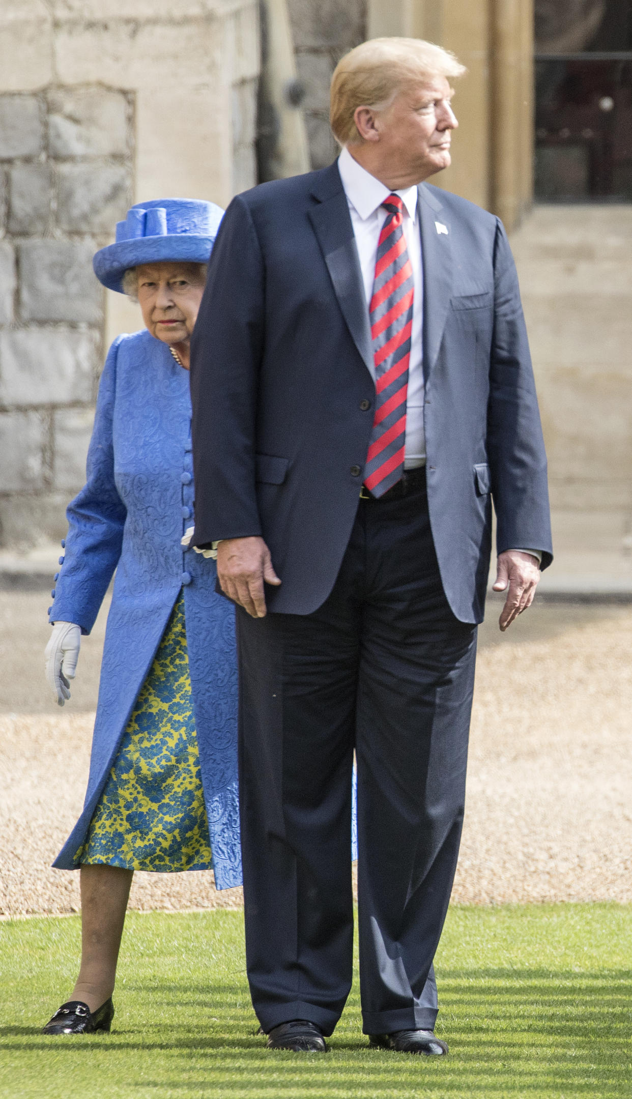 WINDSOR, ENGLAND - JULY 13:  U.S. President Donald Trump and Britain's Queen Elizabeth II inspect a Guard of Honour, formed of the Coldstream Guards at Windsor Castle on July 13, 2018 in Windsor, England.  Her Majesty welcomed the President and Mrs Trump at the dais in the Quadrangle of the Castle. A Guard of Honour, formed of the Coldstream Guards, gave a Royal Salute and the US National Anthem was played. The Queen and the President inspected the Guard of Honour before watching the military march past. The President and First Lady then joined Her Majesty for tea at the Castle.  (Photo by Richard Pohle  - WPA Pool/Getty Images)