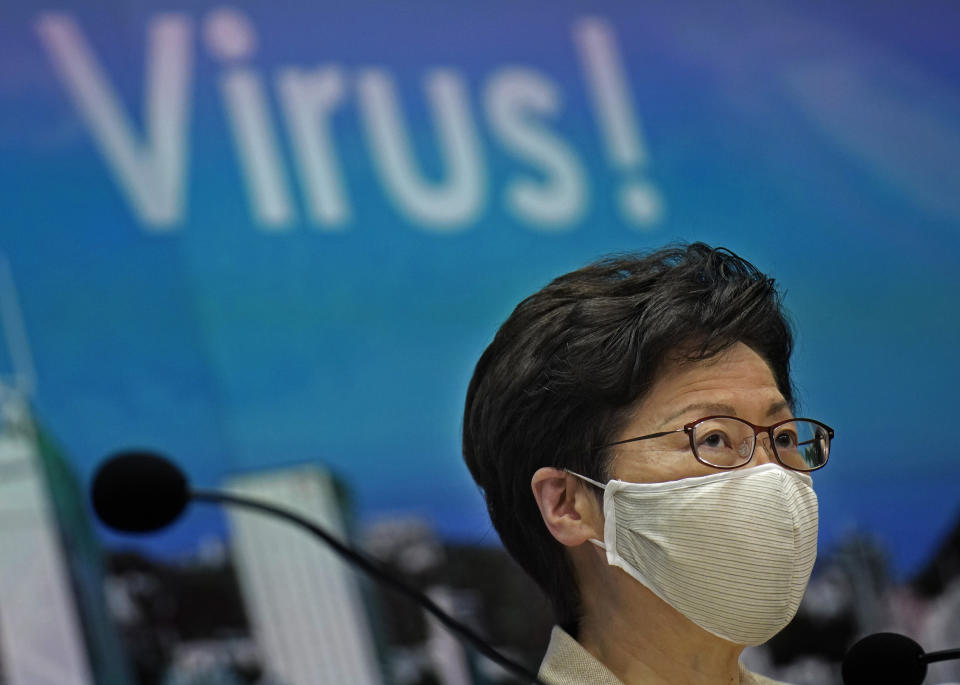 Hong Kong Chief Executive Carrie Lam listens to reporters questions during a press conference held in Hong Kong, Sunday, July 19, 2020. Lam introduced renewed anti-virus measures Sunday, saying the southern Chinese city's situation is "really critical" and adding that she sees "no sign" that it's under control. The new restrictions make mask wearing mandatory in any public place including inside buildings, and put non-essential civil servants back to work at home. (AP Photo/Vincent Yu)