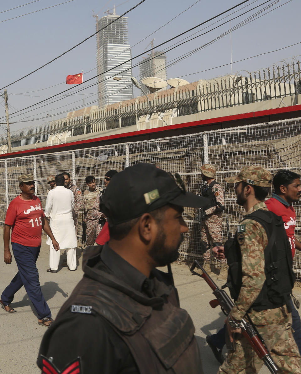 Pakistani security personnel move in the compound of Chinese Consulate in Karachi, Pakistan, Friday, Nov. 23, 2018. Pakistani police say gunmen have stormed the Chinese Consulate in the country's southern port city of Karachi, triggering an intense shootout. (AP Photo/Shakil Adil)