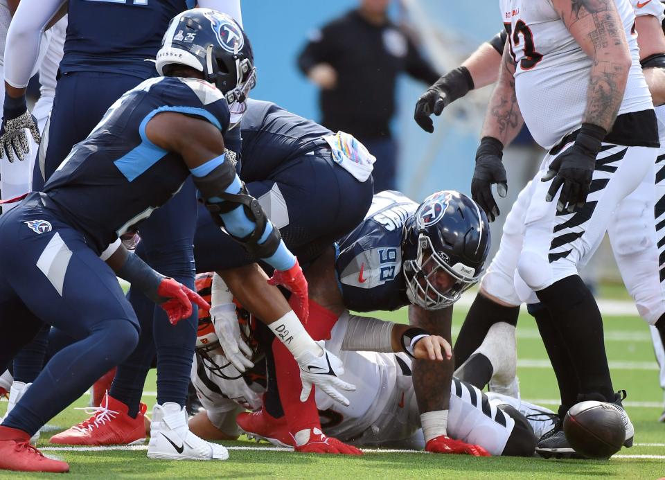 Oct 1, 2023; Nashville, Tennessee, USA; Cincinnati Bengals quarterback Joe Burrow (9) loses the ball as he is sacked during the second half against the Tennessee Titans at Nissan Stadium.