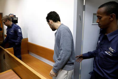 FILE PHOTO: An U.S.-Israeli teen, who was arrested in Israel on suspicion of making bomb threats against Jewish community centres in the United States, Australia and New Zealand, arrives before the start of a remand hearing at Magistrate's Court in Rishon Lezion, Israel April 20, 2017. REUTERS/ Amir Cohen/File Photo