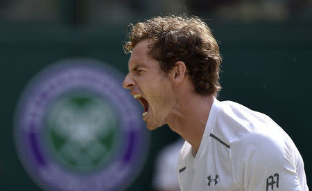 Andy Murray of Britain celebrates after winning the first set of his match against Ivo Karlovic of Croatia at the Wimbledon Tennis Championships in London, July 6, 2015. REUTERS/Toby Melville