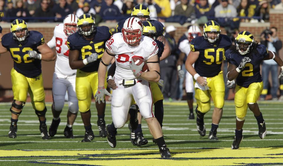 Wisconsin lineman J.J. Watt is chased by the Michigan offensive line after intercepting a deflected pass deflected during the fourth quarter of a NCAA college football game in Ann Arbor, Mich., Saturday, Nov. 20, 2010. (AP Photo/Carlos Osorio)