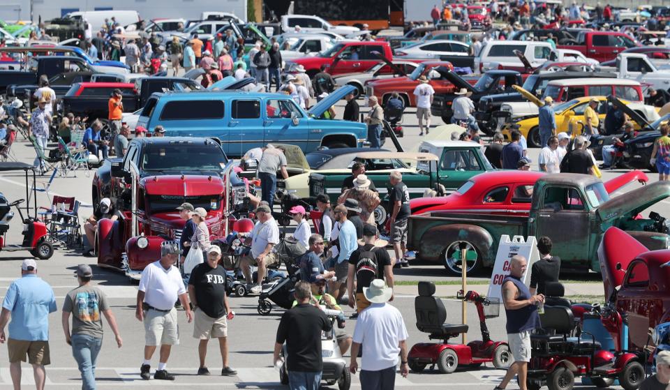 Car enthusiasts check out the rides in the infield, Friday, March 25, 2022, during the Spring Daytona Turkey Rod Run at Daytona International Speedway.