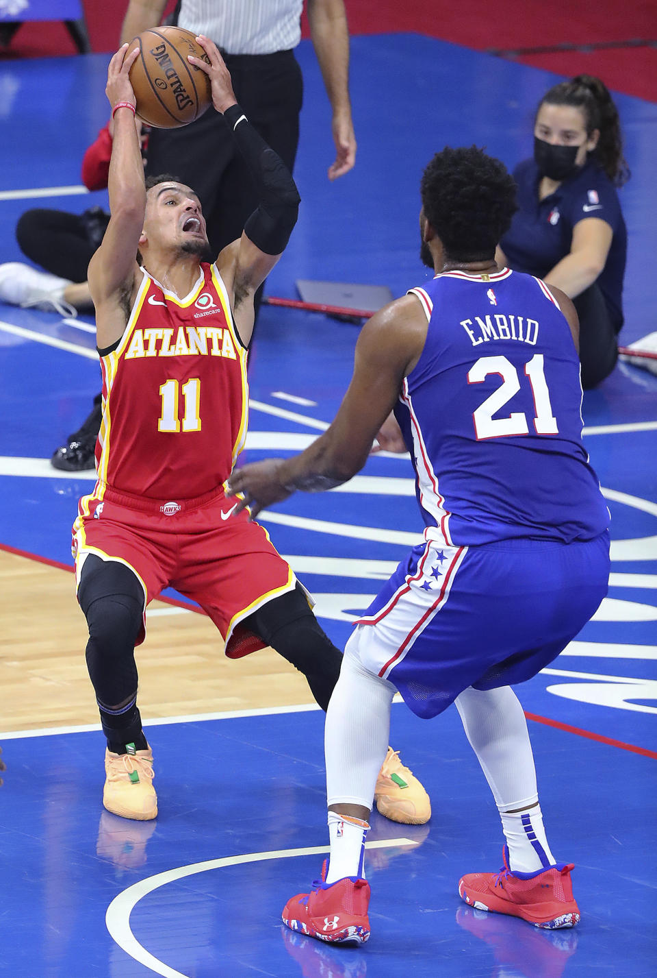 Atlanta Hawks guard Trae Young is defended by Philadelphia 76ers center Joel Embiid during Game 2 of an NBA basketball Eastern Conference semifinal series Tuesday, June 8, 2021, in Philadelphia. (Curtis Compton/Atlanta Journal-Constitution via AP)