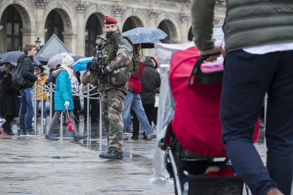 A French soldier patrols in the courtyard of the Louvre museum in Paris, Saturday, Feb. 4, 2017. The Louvre in Paris reopened to the public Saturday morning, less than 24-hours after a machete-wielding assailant shouting "Allahu Akbar!" was shot by soldiers, in what officials described as a suspected terror attack.(AP Photo/Kamil Zihnioglu)