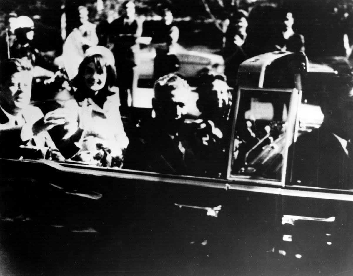 President John F Kennedy and first lady Jacqueline Kennedy in an open car motorcade shortly before the president was assassinated in Dallas, Texas (Getty Images)