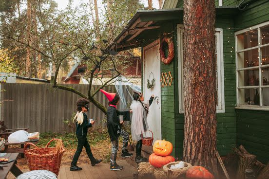 group of children trick or treating during halloween