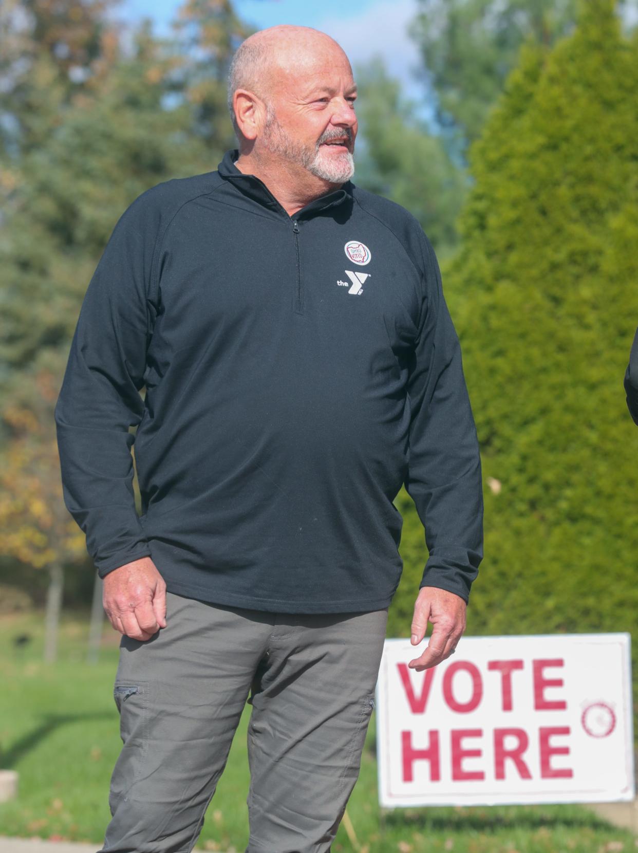 Craig Greenlee talks about how he voted on issues 1 and 2 while standing in front of the polling place at Queen of Heaven Catholic Church in Green.