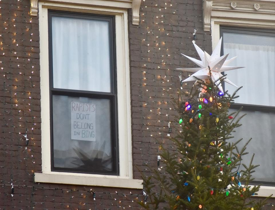A hand-drawn sign posted Friday, Dec. 10, in a third-floor window above the Colonial reads: "Rapists don't belong in Bing."