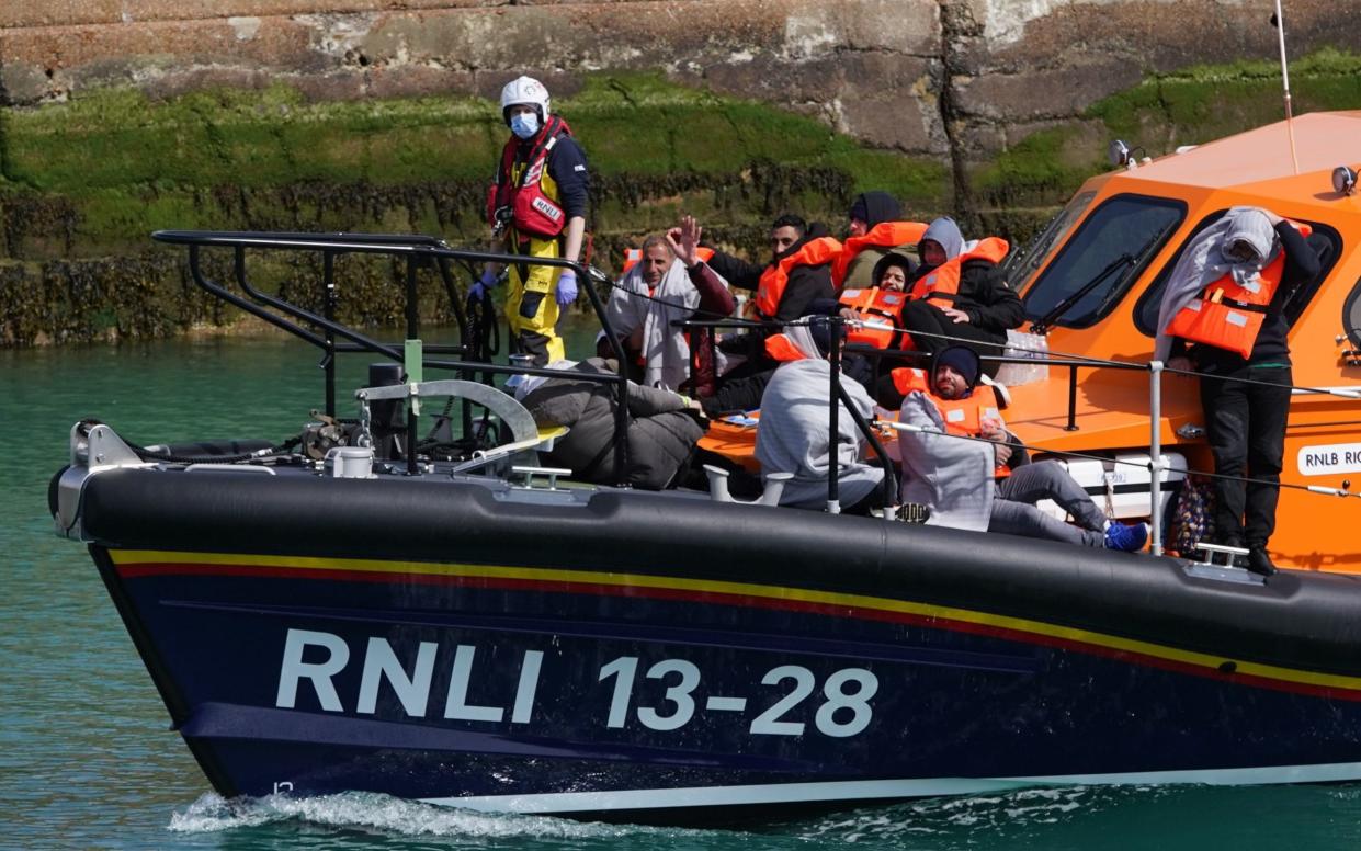 A group of people thought to be migrants are brought in to Dover, Kent, by the RNLI