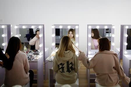 Girls attend make-up training session at live streaming talent agency Three Minute TV, in Beijing, China, February 15, 2017. Picture taken February 15, 2017. REUTERS/Thomas Peter