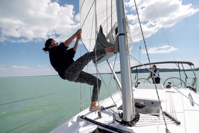 Barczi, member of a boat rental agency, pulls the sail on a sailing boat on Lake Balaton, following the outbreak of the coronavirus disease (COVID-19), near Balatonfured