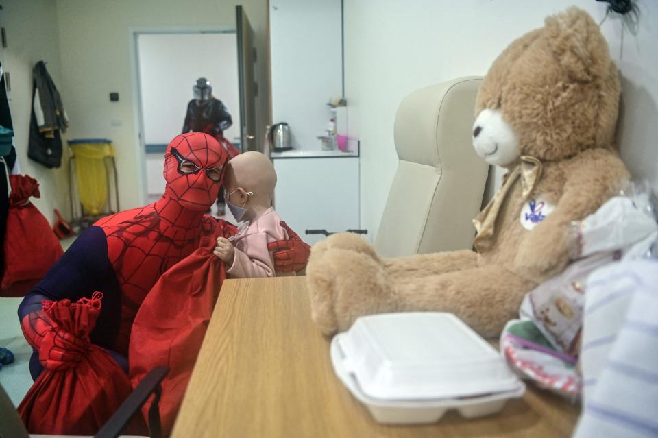 A man dressed as comic-based superhero Spiderman entertains a child at the children hospital in Pristina on December 15, 2023 during an event organized by "Care for Kosovo Kids" a Dutch organization which provides lifesaving medicines for children fighting cancer in Kosovo.