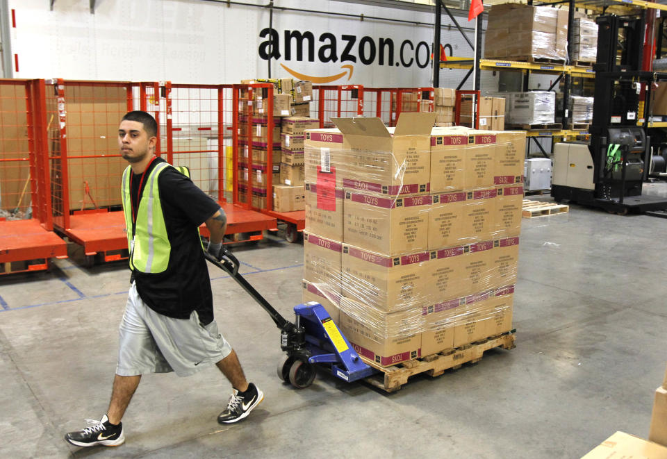 FILE - In this Nov. 11, 2010 file photo, Humberto Manzano, Jr., delivers an arriving pallet of goods at an Amazon.com fulfillment center in Phoenix.  Products are flying off the shelves at Amazon warehouses across the county as Californians prepare to start paying sales taxes on online purchases. The change, which takes effect Saturday, Sept. 15, 2012, will pave the way for the e-commerce giant to open warehouses in California and offer same-day shipping to customers.  (AP Photo/Ross D. Franklin, file)