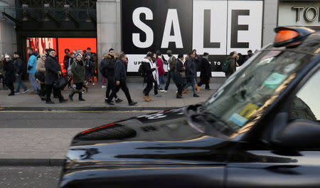 FILE PHOTO: Shoppers and tourists walk along Oxford Street during the sales in central London, Britain, December 28, 2017. REUTERS/Russell Boyce/File Photo