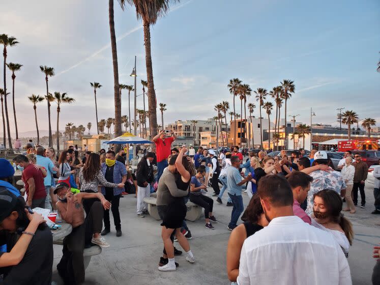 Approaching a new dance floor is always intimidating. Here, Angelenos dance to salsa and bachata near the Venice Pier as Covid-19 figures continue to drop and restrictions ease.