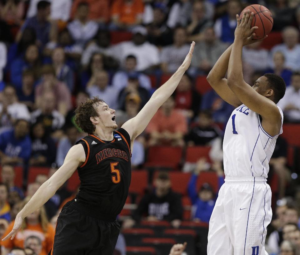 Duke forward Jabari Parker (1) shoots against Mercer forward Bud Thomas (5) during the first half of an NCAA college basketball second-round game, Friday, March 21, 2014, in Raleigh, N.C. (AP Photo/Chuck Burton)