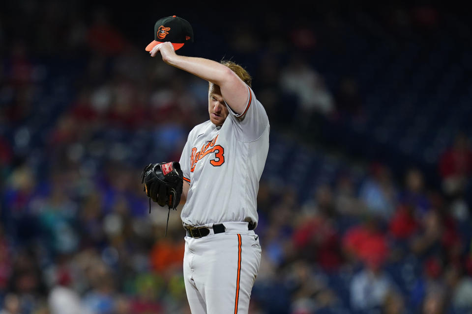 Baltimore Orioles pitcher Thomas Eshelman wipes his face during the sixth inning of an interleague baseball game against the Philadelphia Phillies, Tuesday, Sept. 21, 2021, in Philadelphia. (AP Photo/Matt Slocum)