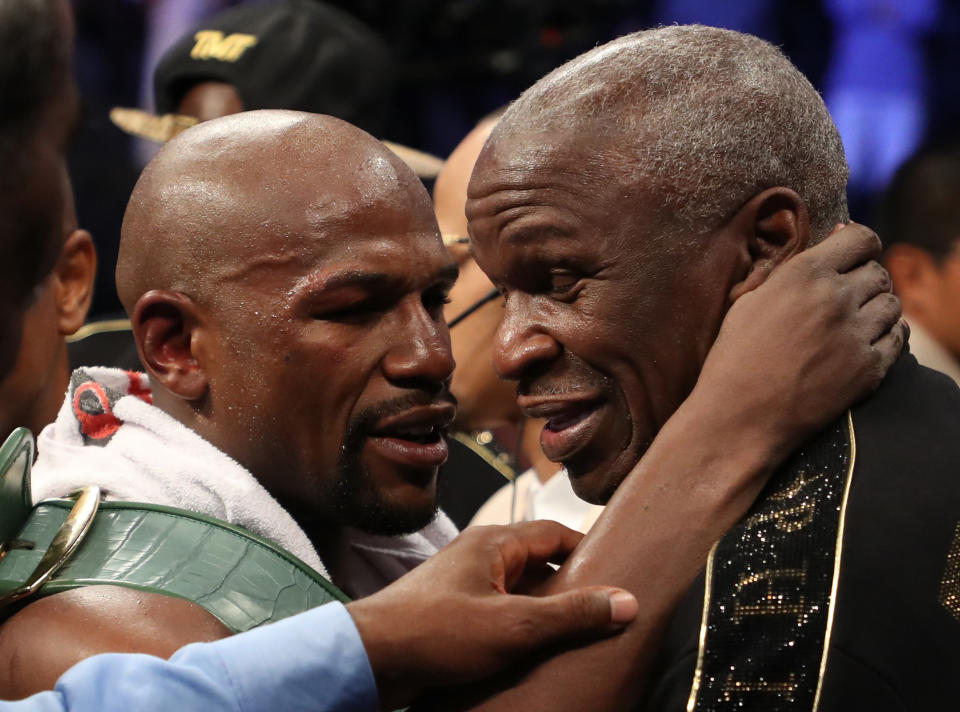 LAS VEGAS, NV - AUGUST 26:  (L-R) Floyd Mayweather Jr. hugs Floyd Mayweather Sr. after defeating Conor McGregor by TKO in their super welterweight boxing match on August 26, 2017 at T-Mobile Arena in Las Vegas, Nevada.  (Photo by Christian Petersen/Getty Images)