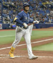 Tampa Bay Rays' Wander Franco smiles toward the dugout after earning a walk against Miami Marlins reliever Zach Thompson during the sixth inning of a baseball game Friday, Sept. 24, 2021, in St. Petersburg, Fla. Franco extended his on-base streak to 40 games. (AP Photo/Steve Nesius)