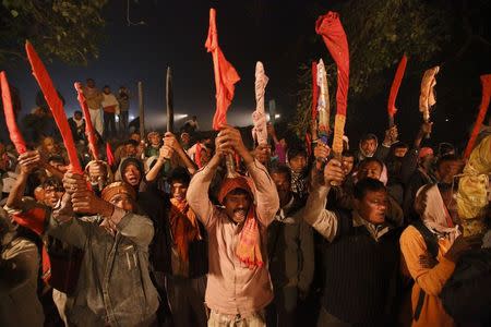 Butchers raise their swords while performing rituals before the sacrificial ceremony of the "Gadhimai Mela" festival held in Bariyapur November 28, 2014. REUTERS/Navesh Chitrakar