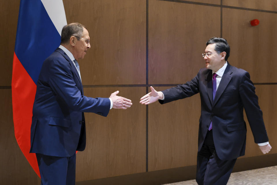 In this handout photo released by Russian Foreign Ministry Press Service, Russian Foreign Minister Sergey Lavrov, left, and Chinese Foreign Minister Qin Gang shake hands during their meeting in Samarkand, Uzbekistan, Thursday, April 13, 2023. (Russian Foreign Ministry Press Service via AP)