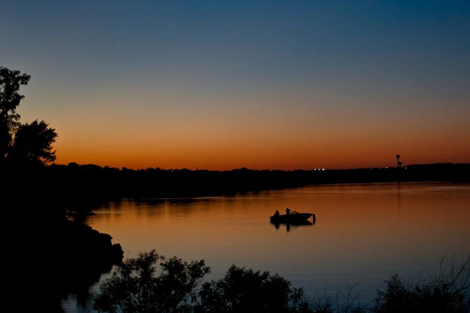 Anglers cast a line as the sun sets on Arcadia Lake.