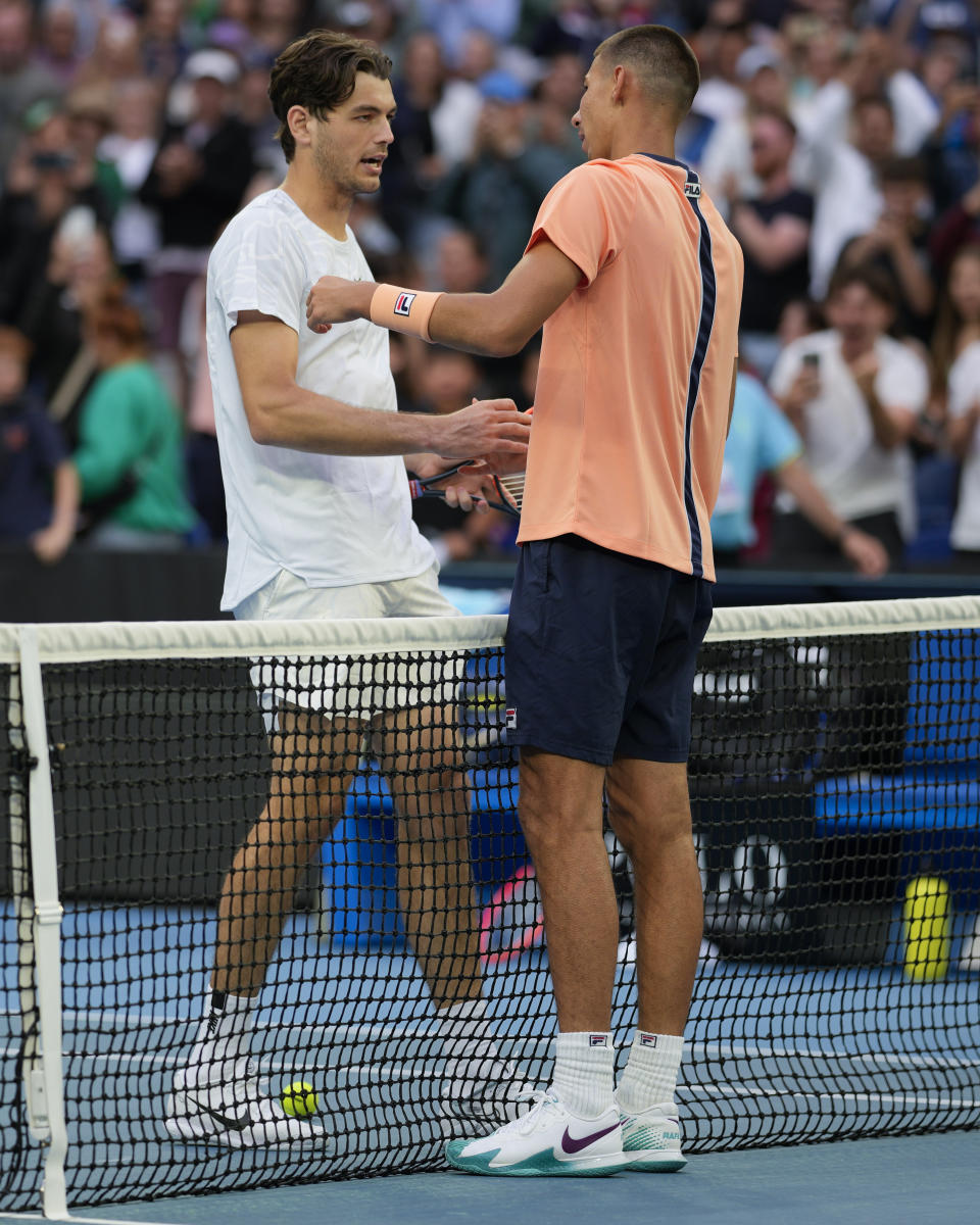 Alexei Popyrin of Australia is congratulated by Taylor Fritz, left, of the U.S. following their second round match at the Australian Open tennis championship in Melbourne, Australia, Thursday, Jan. 19, 2023. (AP Photo/Aaron Favila)