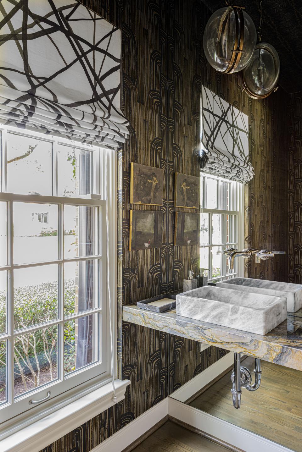 “I’m crazy for this bathroom,” admits Loya. “Mixing marbles excites me so much!” Globe chandeliers by Arteriors play off the Roman shades made by Loya with Kelly Wearstler Channel fabric, but guests get a kick out of the sink, which Loya had custom-made. “I love mixing patterns, whether you use color or not. It gives an interesting, textural feeling to a small space—and this tiny powder room needed to be full of personality,” she says.