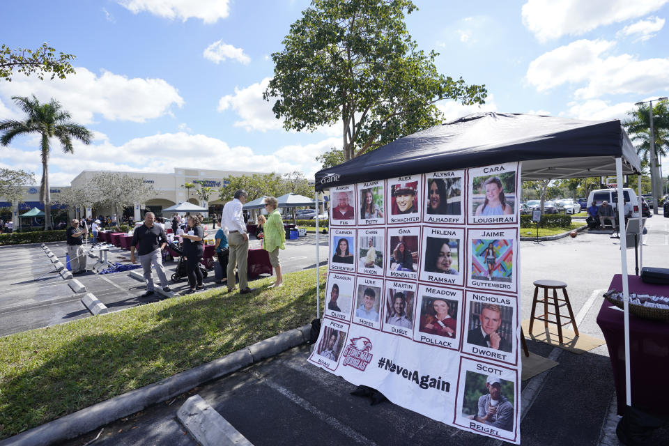 The photos of the Parkland, Fla., shooting are displayed, Tuesday, Feb. 14, 2023, at a ceremony in Coral Springs, Fla., honoring the lives of the 17 students and staff of Marjory Stoneman Douglas High School that were killed on Valentine's Day, 2018. (AP Photo/Wilfredo Lee)