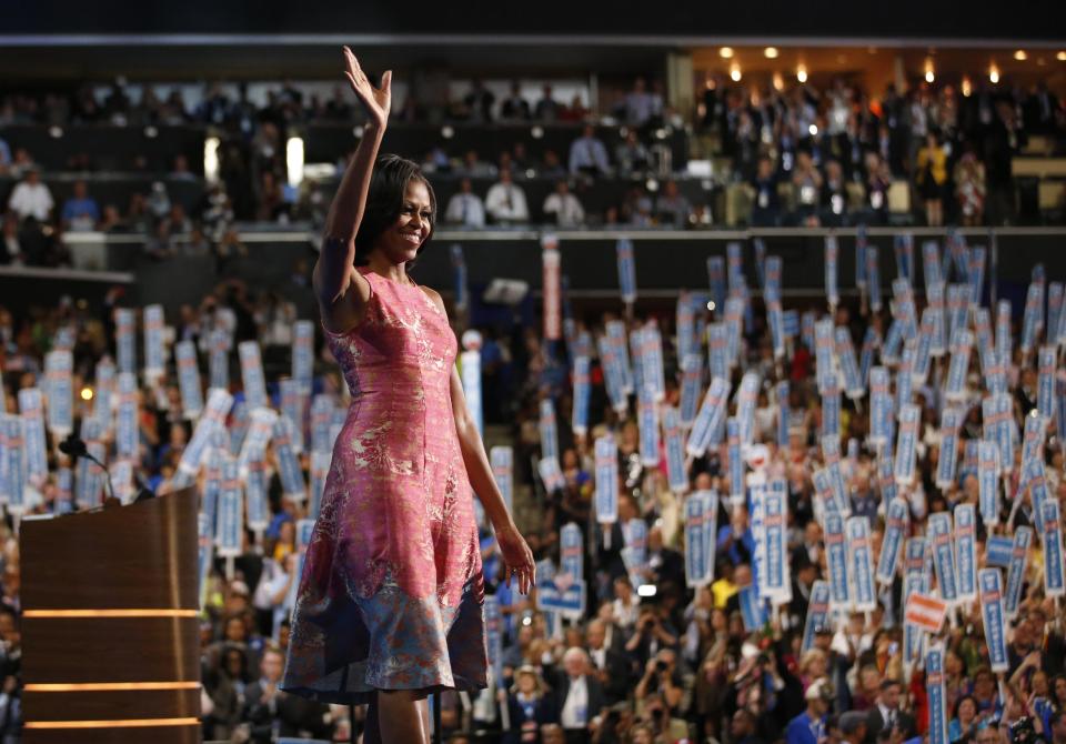 FILE - In this Tuesday, Sept. 4, 2012 file photo, first lady Michelle Obama waves after addressing the Democratic National Convention in Charlotte, N.C. Tracy Reese, who designed Obama's pink silk jaquard dress with pale blue trim at the hem, says she's rushing to make more of them. Reese told NBC's "Today" show that the dress will cost under $500. (AP Photo/Jae C. Hong, File)