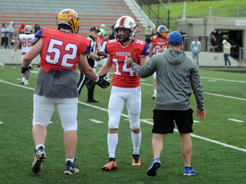Dalton Patterson, of Ridgewood, is congratulated by his South squad teammates following a fourth-quarter stop during the annual Ohio North-South All-Star Football Classic on Saturday at Paul Brown Tiger Stadium in Massillon.