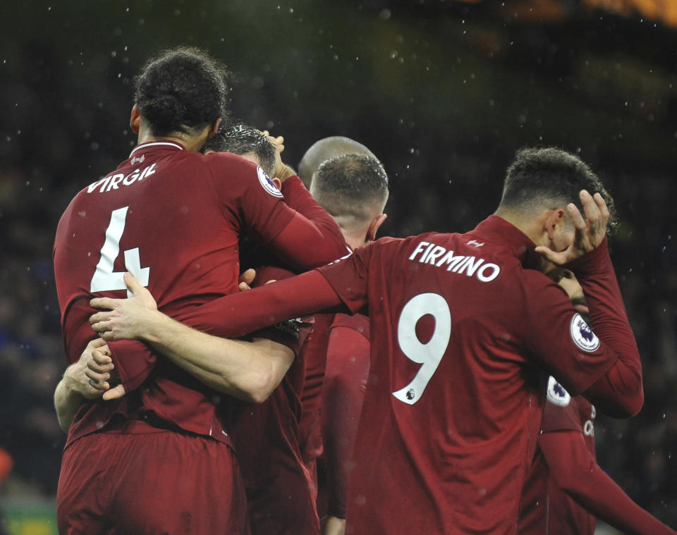 Liverpool players celebrate after Liverpool's Virgil van Dijk scored his side's second goal during the English Premier League soccer match between Wolverhampton Wanderers and Liverpool at the Molineux Stadium in Wolverhampton, England, Friday, Dec. 21, 2018. (AP Photo/Rui Vieira)