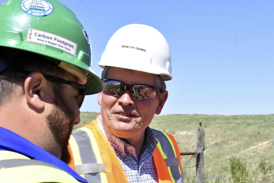 Republican Sen. Steve Daines speaks with a worker at Westmoreland Mining's Rosebud coal mine Tuesday, May 28, 2024, in Colstrip, Mont. Daines and other Republicans are pushing back against new restrictions against coal-burning power plants and coal leases on federal lands from the Biden administration. (AP Photo/Matthew Brown)