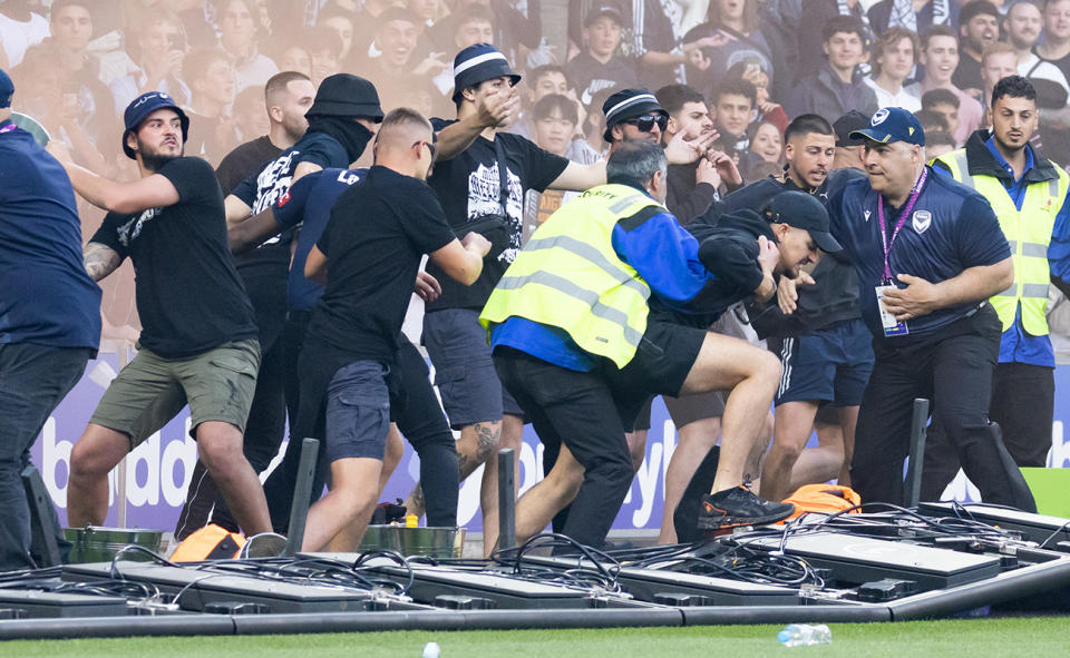 Fans, pictured here invading the pitch during the A-League derby between Melbourne City and Melbourne Victory.