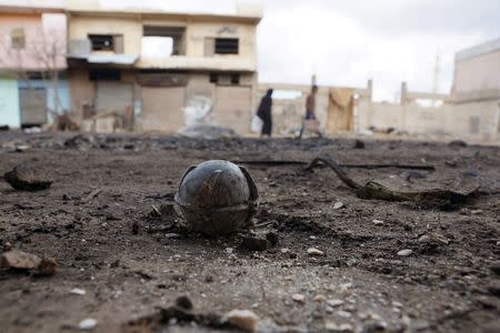 An unexploded cluster bomblet is seen along a street after airstrikes by pro-Syrian government forces in the rebel held al-Ghariyah al-Gharbiyah town, in Deraa province, Syria February 11, 2016. REUTERS/Alaa Al-Faqir