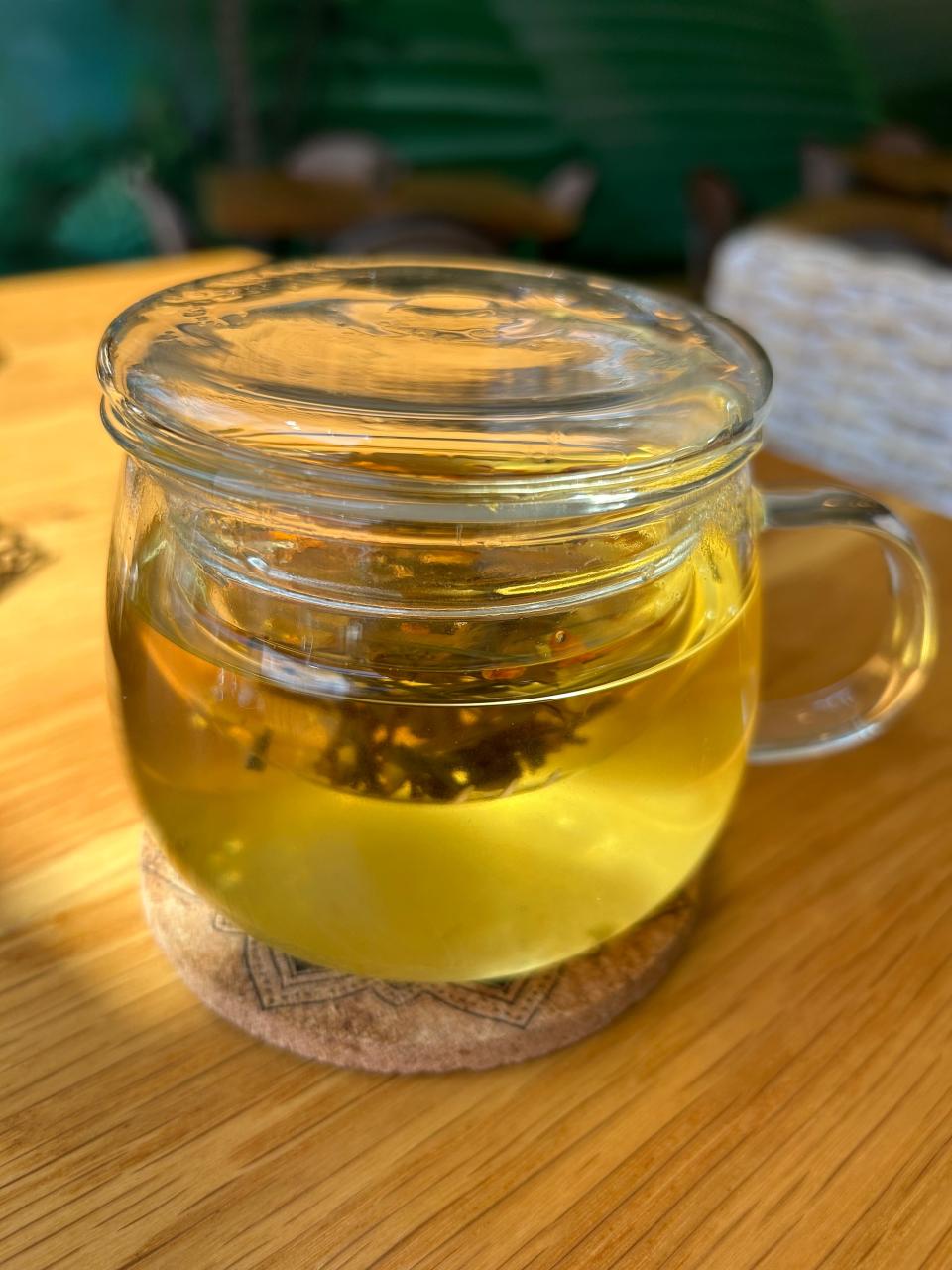 Specially made tea cups at SRINA feature a large glass tea cup with a built-in, glass infuser bowl inside. A glass top doubles as a stand for the infuser bowl as customers drink their tea.