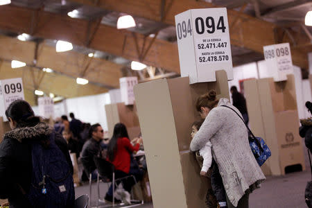 Woman votes in a seven-question referendum on anti-corruption measures in Bogota, Colombia August 26, 2018. REUTERS/Luisa Gonzalez