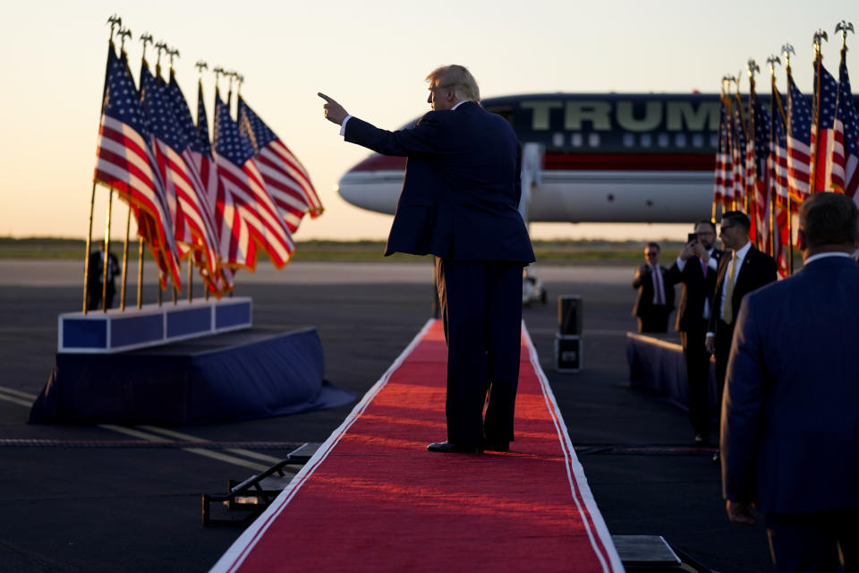 Former President Donald Trump points to the crowd as he leaves after speaking at a campaign rally at Waco Regional Airport, Saturday, March 25, 2023, in Waco, Texas. (AP Photo/Evan Vucci)